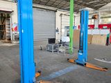 two blue lifts in the middle of a building