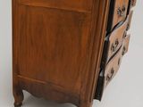 a small wooden chest of drawers with a drawer underneath it