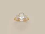an oval white diamond ring with three pear shaped diamonds on the band