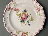 a close up of a plate with flowers on it on a table