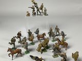 many figurines of soldiers on display on a white surface