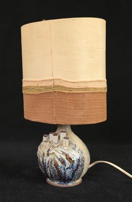 a lamp that is sitting on a table with a black background