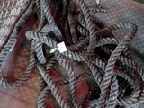 a pile of rope sitting on the floor next to a chair