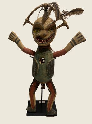 an image of a wooden sculpture of a man with feathers on his head