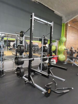 a picture of a gym room with a weight rack and weights