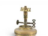a brass candle holder with a crown on top