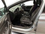 a silver car with the door open and the driver seat down