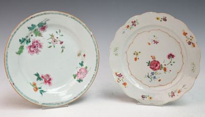 two plates with floral designs are sitting side by side on a white surface