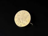 a close up of a coin on a black surface