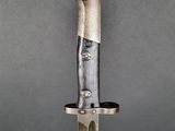 a close up of a knife with a metal handle