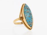 a gold ring with a turquoise stone in the center