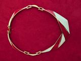 a close up of a red and white bracelet on a red surface
