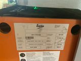 an orange refrigerator with a sticker on the side of it