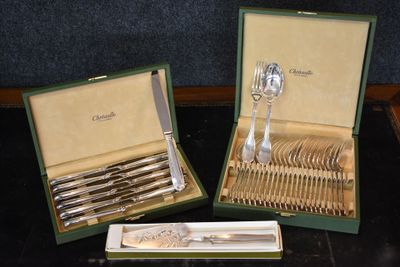 two sets of silverware in a box on a table