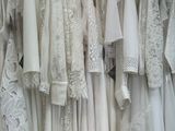 a lot of dresses hanging on a rack in a store
