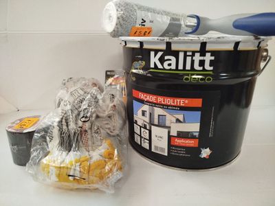 a bucket of paint next to a bucket of paint and a roll of tape