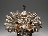 a silver crown with a cross on top of it