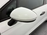 a side view mirror of a white car on the side of the road