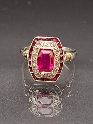 an image of a ring with a ruby stone in the center