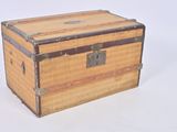 a small wooden box with metal handles on a white surface