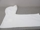 a white towel that is laying on a couch