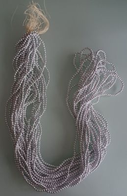 beaded necklace with silver beads on a gray background
