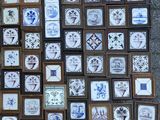 a lot of blue and white tile pictures on the ground