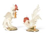 two figurines of a rooster and a chicken on a table