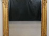 an image of a gold framed mirror with a black background