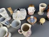 many cups and saucers that are sitting on a table