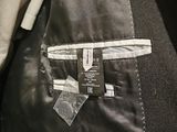 the back of a black jacket with a white label on it