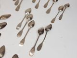 a lot of silver spoons and spoon spoons on the table