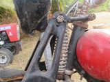 a close up of a motorcycle with a red ball on the handlebar