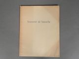 the book is open on a gray surface with a black and white picture