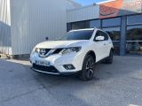 un SUV Nissan blanc garé devant un immeuble