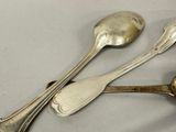 two spoons and two spoons on a table
