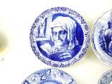 three blue and white plates with a picture of an old man and a woman on them