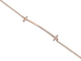 a rose gold bracelet with a cross on a chain