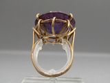 an amethorate and gold ring with a purple stone