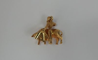 a gold plated elephant with a rider on it ' s back