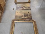 several framed paintings on the floor in a room