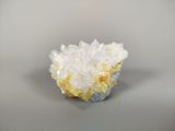 crystal cluster on a gray surface with a white background