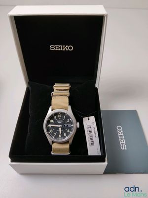 the watch is in a box with a tag on it