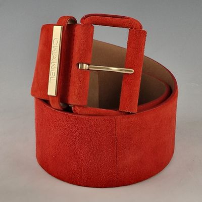 a red belt with a gold buckle on it