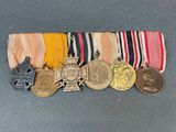 an assortment of medals including a medal, a cross, and a medal
