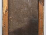 an old wooden frame with a blackboard on the wall