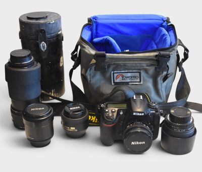 many cameras and a camera bag on the table