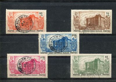 six different colored stamps on a black surface with a black background