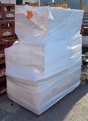 a large stack of white paper sitting on a pallet