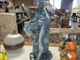 une statue de femme assise sur une table